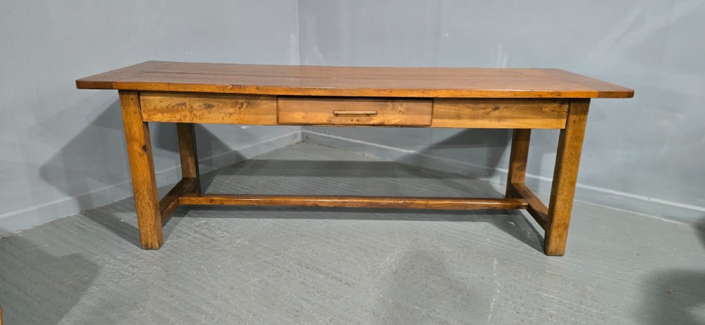 A long wooden French farmhouse refectory dining table featuring a central frieze drawer and lower stretcher bar. View II