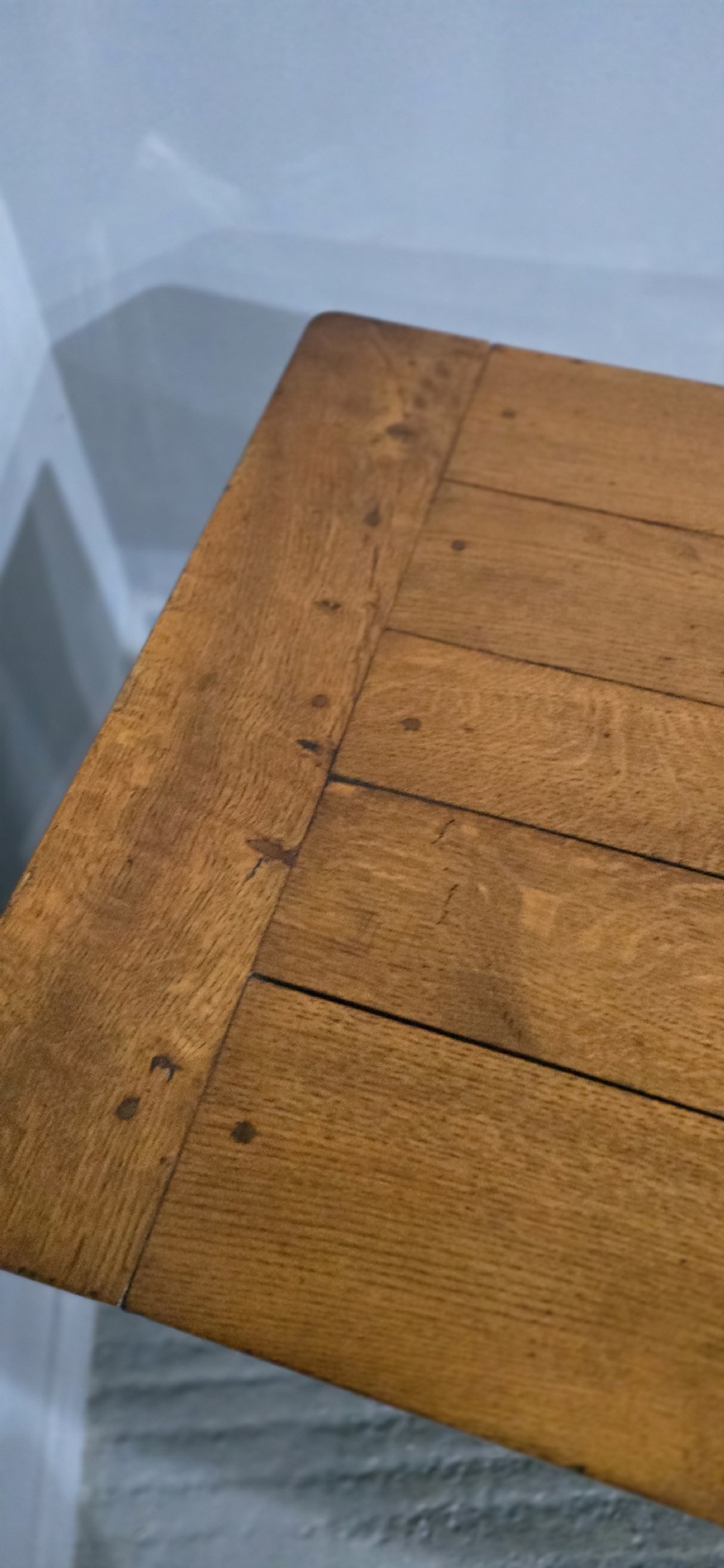 A long wooden French farmhouse refectory dining table featuring a central frieze drawer and lower stretcher bar. View IX