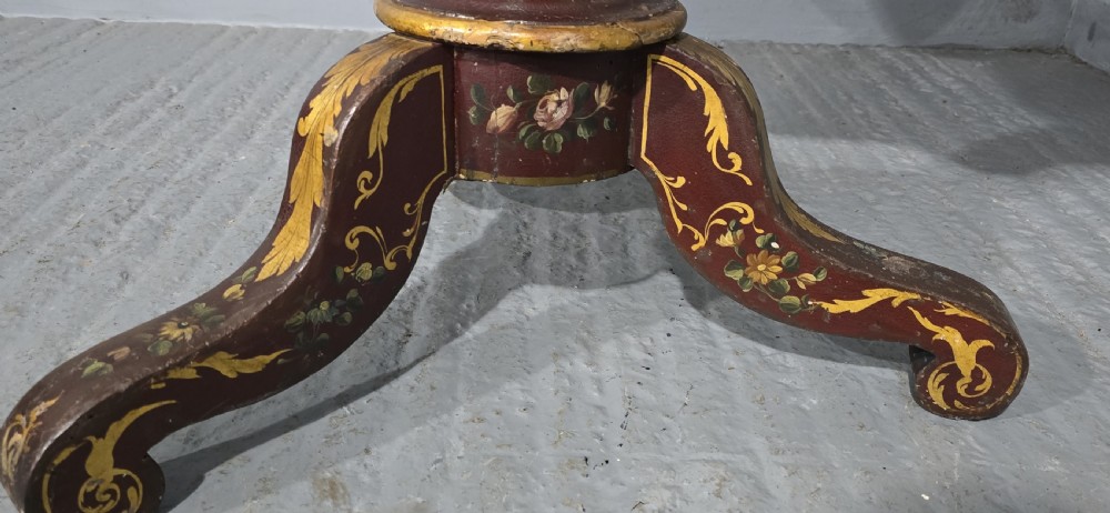 An Italian painted tilt-top side table featuring a dark burgundy ground decorated with a central hand-painted floral bouquet and gilt scrollwork borders. View XI