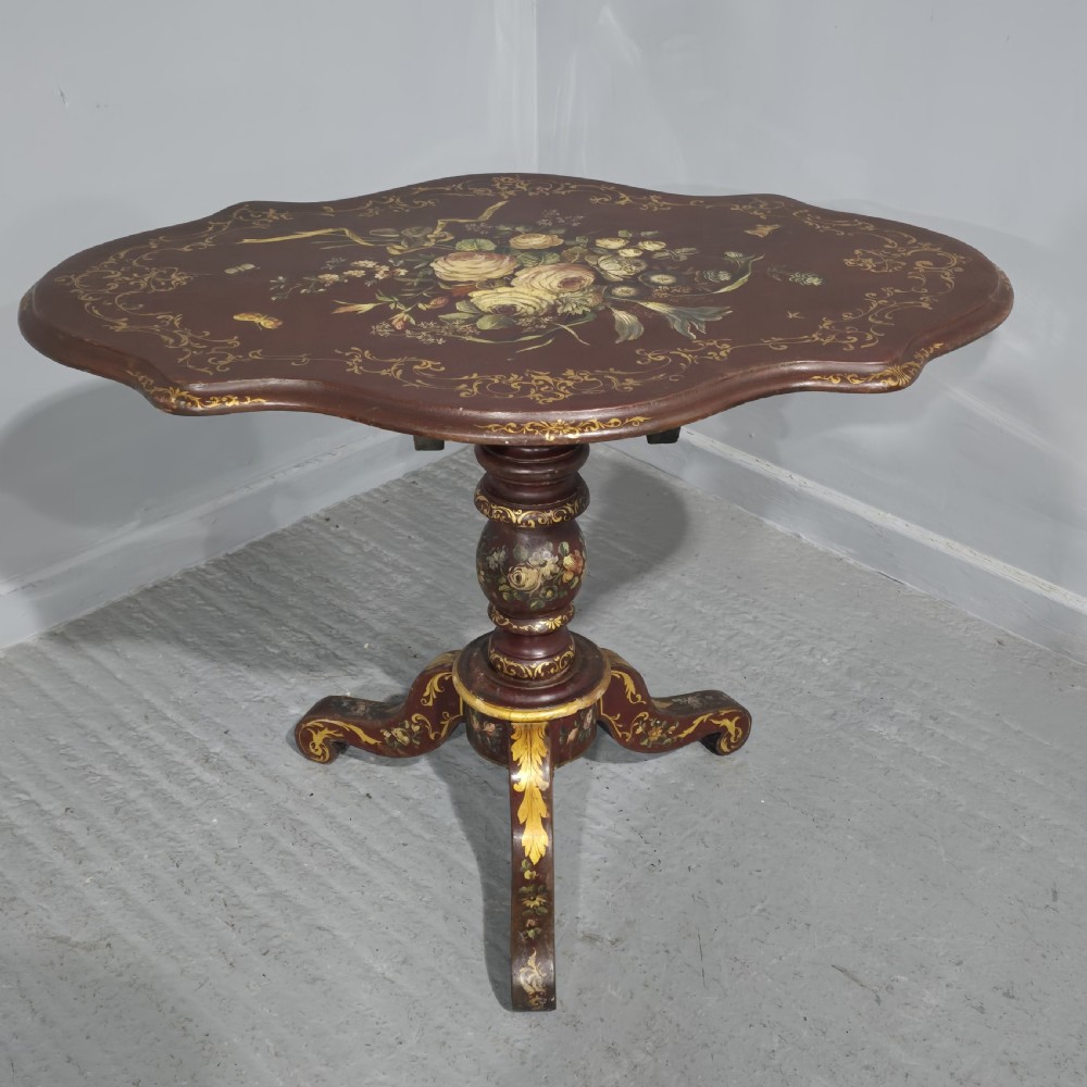 An Italian painted tilt-top side table featuring a dark burgundy ground decorated with a central hand-painted floral bouquet and gilt scrollwork borders. View XIII