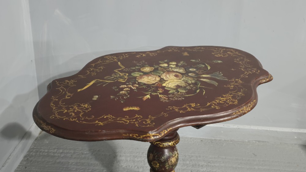 An Italian painted tilt-top side table featuring a dark burgundy ground decorated with a central hand-painted floral bouquet and gilt scrollwork borders. View XV