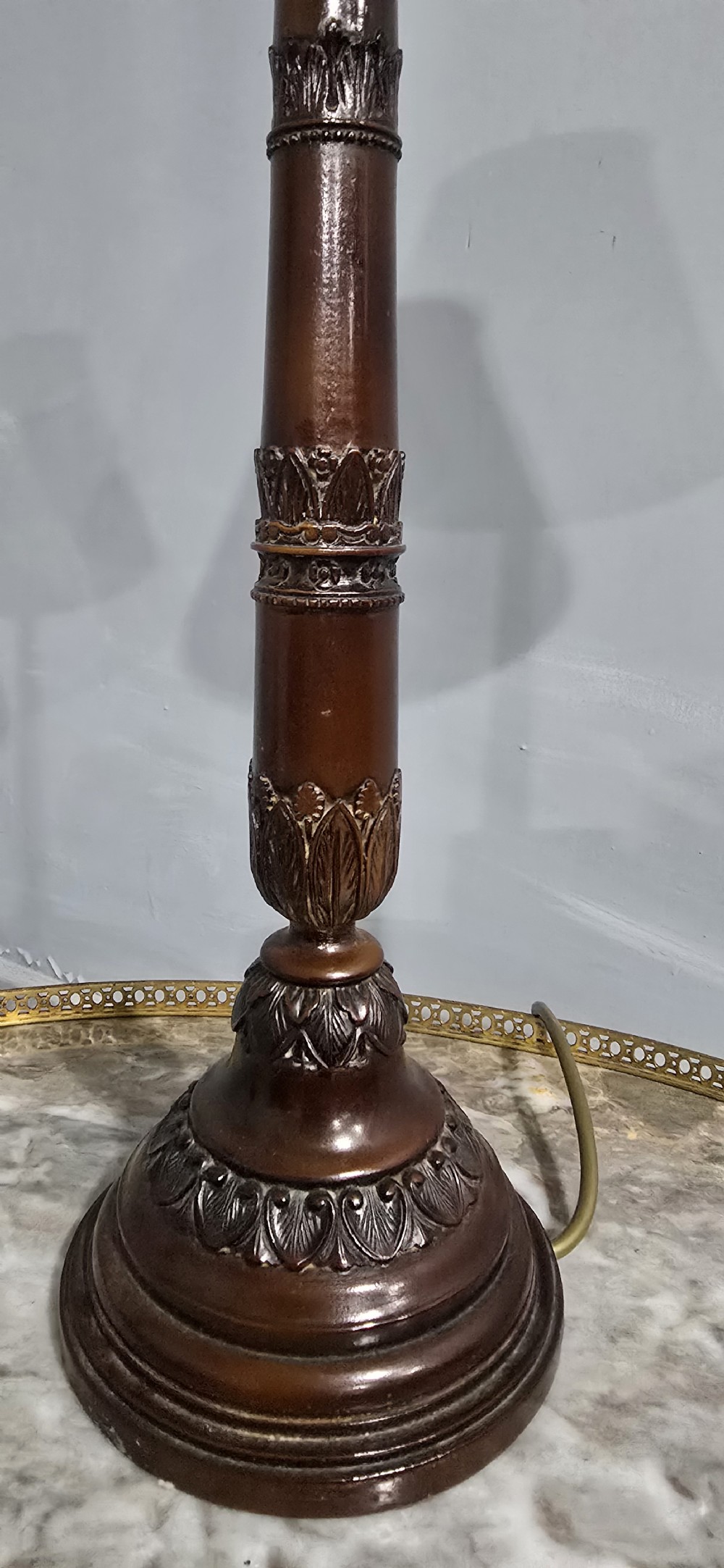 A pair of classic French bronzed table lamps featuring detailed column bases and cream pleated shades. View V
