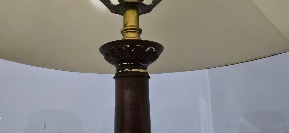 A pair of classic French bronzed table lamps featuring detailed column bases and cream pleated shades. View VII