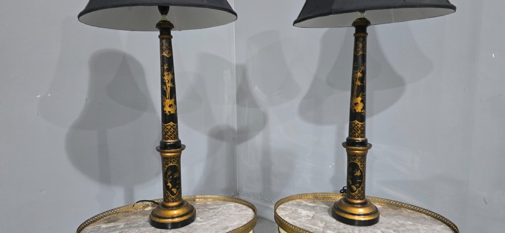 A pair of tall black lacquered table lamps featuring hand-painted gold Chinoiserie motifs and topped with black fabric shades. View III