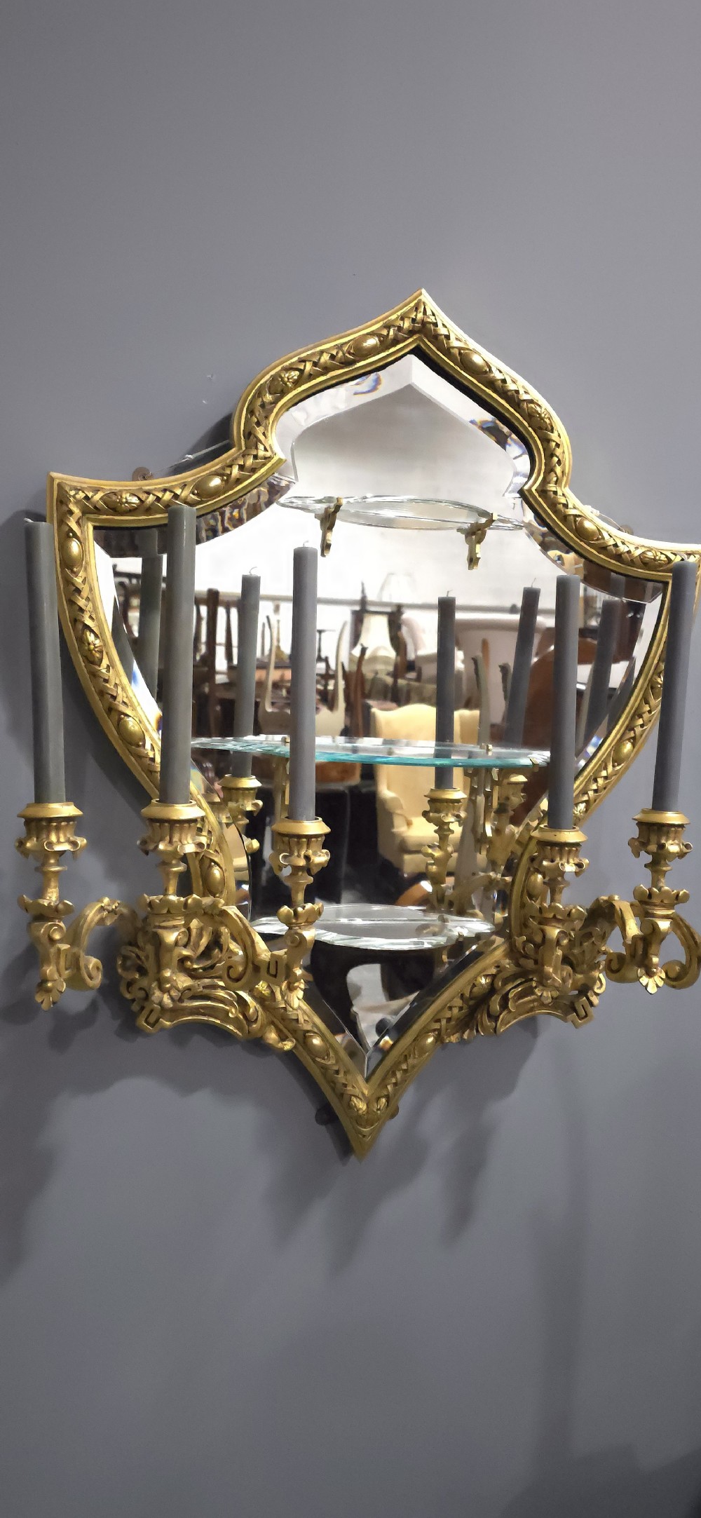 A pair of shaped giltwood girandole wall mirrors featuring ornate carved frames, integrated glass shelves, and multi-branch candle sconces. View VIII