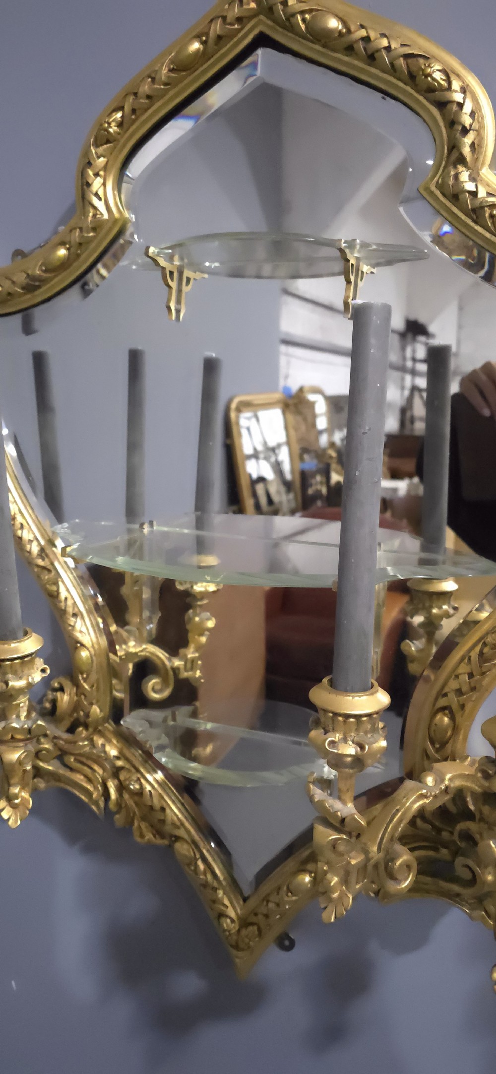 A pair of shaped giltwood girandole wall mirrors featuring ornate carved frames, integrated glass shelves, and multi-branch candle sconces. View X