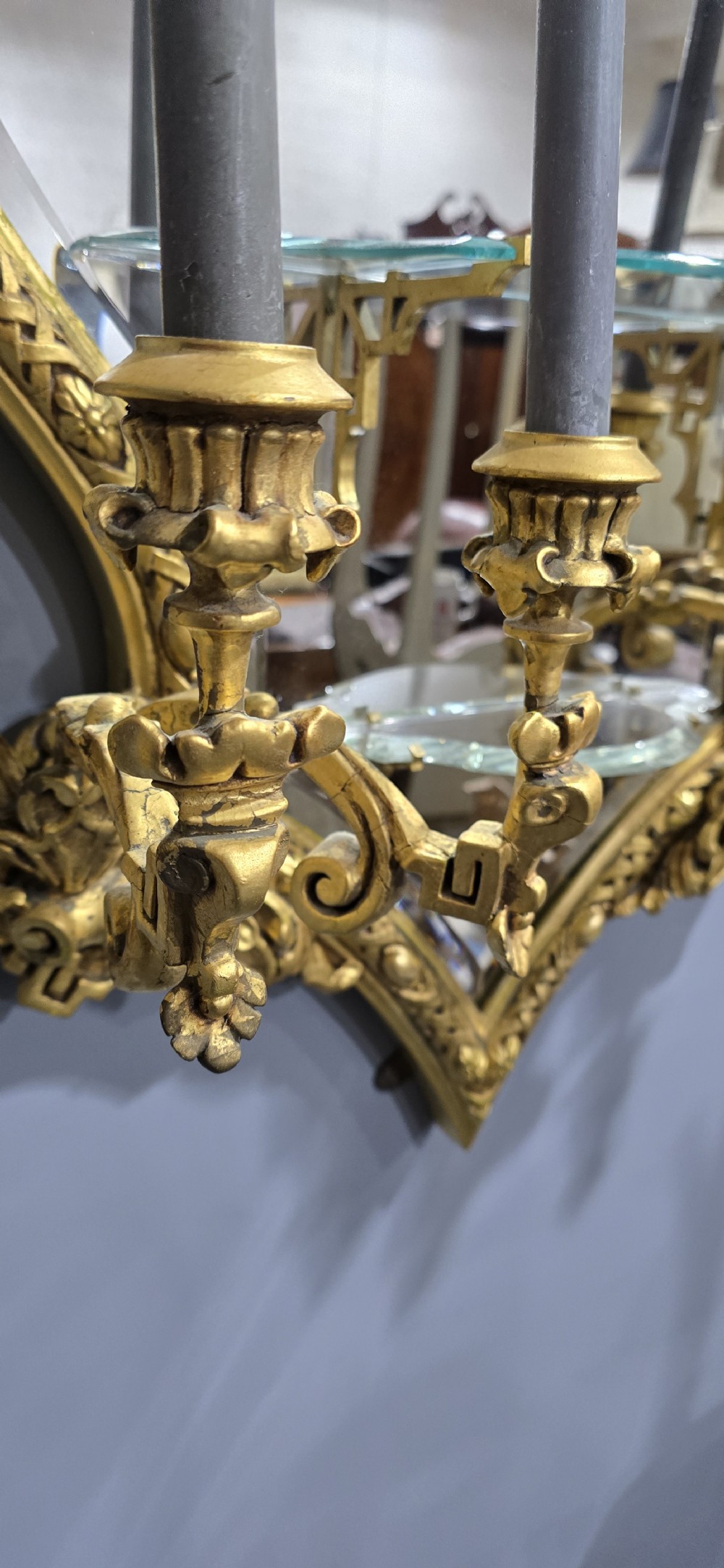 A pair of shaped giltwood girandole wall mirrors featuring ornate carved frames, integrated glass shelves, and multi-branch candle sconces. View XIII
