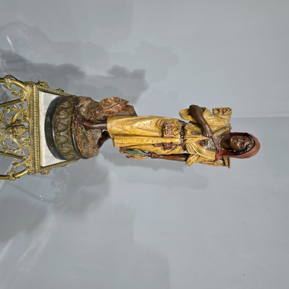 A polychrome terracotta sculpture depicting a standing woman dressed as a fisher girl carrying a basket on her back and holding fish. View VII