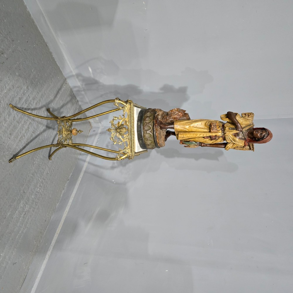 A polychrome terracotta sculpture depicting a standing woman dressed as a fisher girl carrying a basket on her back and holding fish. View VIII