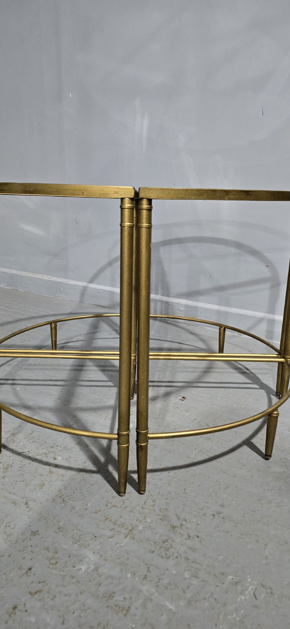 A set of four quadrant-shaped gold brass tables with glass tops arranged together to form a single circular surface. View IV