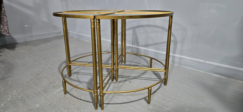 A set of four quadrant-shaped gold brass tables with glass tops arranged together to form a single circular surface. View VI