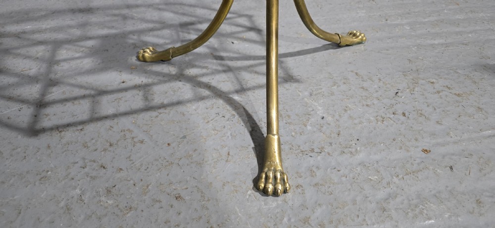A Victorian brass revolving magazine stand featuring a wireframe rack with shaped dividers, supported on a tripod base with paw feet. View IV