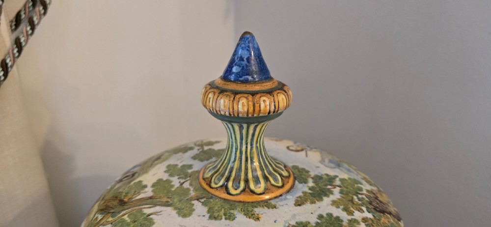 An 18th-century Italian tin-glazed earthenware lidded jar decorated with painted classical landscapes, cherubs, and architectural ruins. View IV