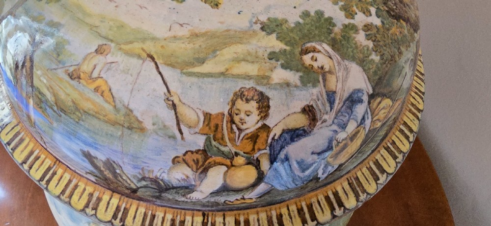 An 18th-century Italian tin-glazed earthenware lidded jar decorated with painted classical landscapes, cherubs, and architectural ruins. View XI