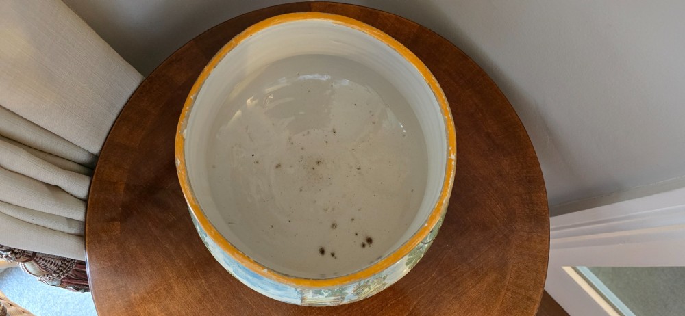 An 18th-century Italian tin-glazed earthenware lidded jar decorated with painted classical landscapes, cherubs, and architectural ruins. View XIV