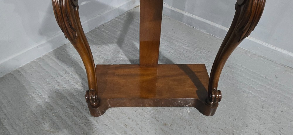 A mahogany console table featuring a green marble top supported by carved scrolled front legs on a plinth base. View VII