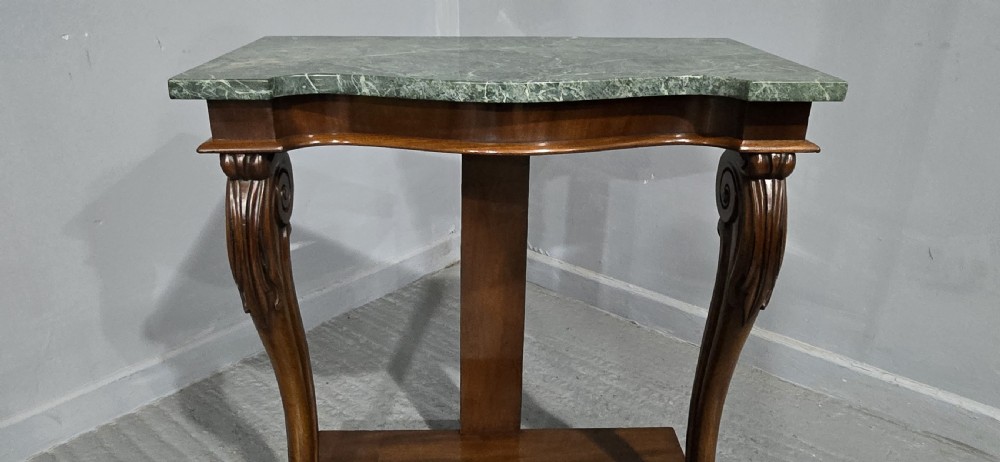 A mahogany console table featuring a green marble top supported by carved scrolled front legs on a plinth base. View VIII