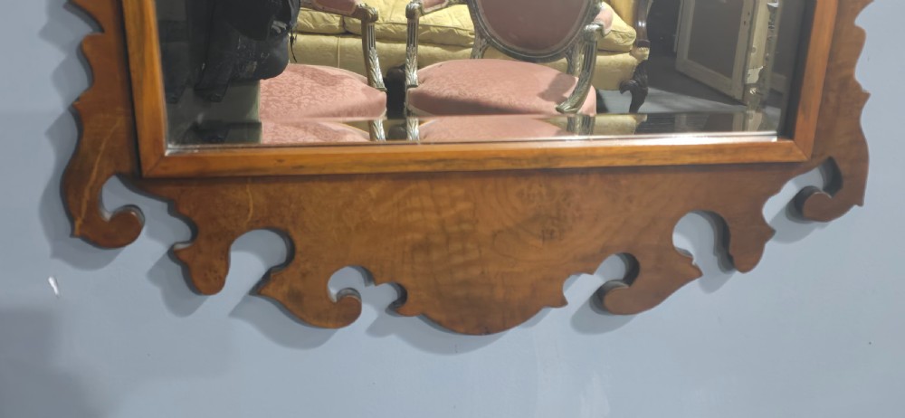 A vertical wall mirror featuring a carved burr walnut frame with scrollwork fretwork at the top crest and bottom apron. View IV