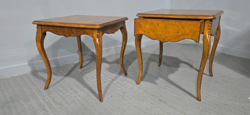 A matching pair of square burr elm lamp tables featuring figured timber tops, shaped friezes, and slender cabriole legs. View V