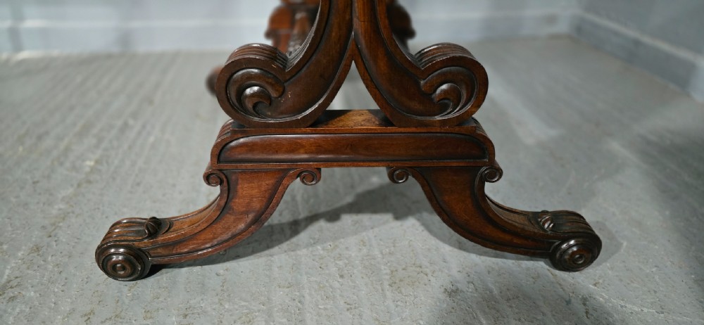 An antique Regency mahogany cheval mirror featuring a rectangular frame set between reeded upright posts on splayed legs. View VIII