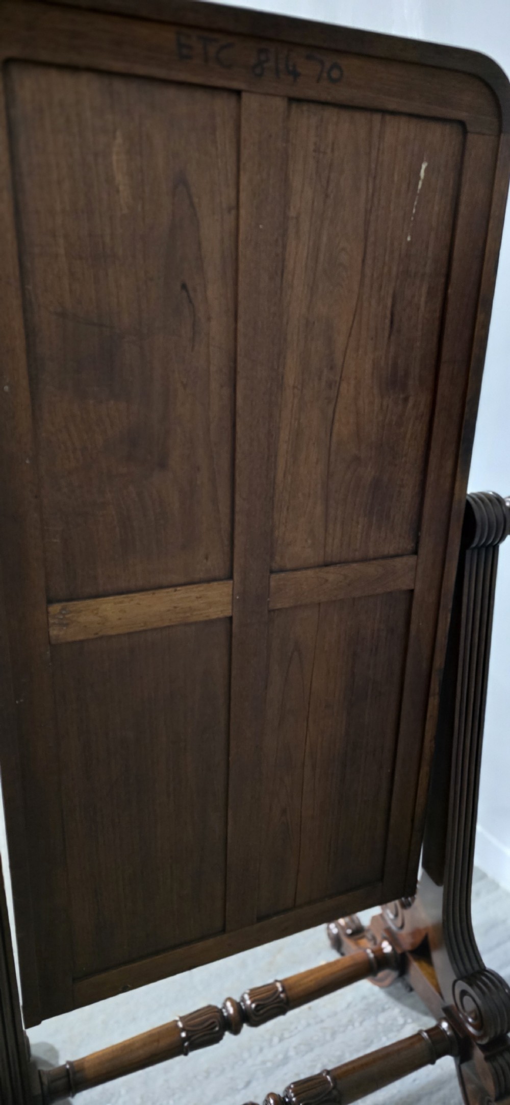 An antique Regency mahogany cheval mirror featuring a rectangular frame set between reeded upright posts on splayed legs. View X