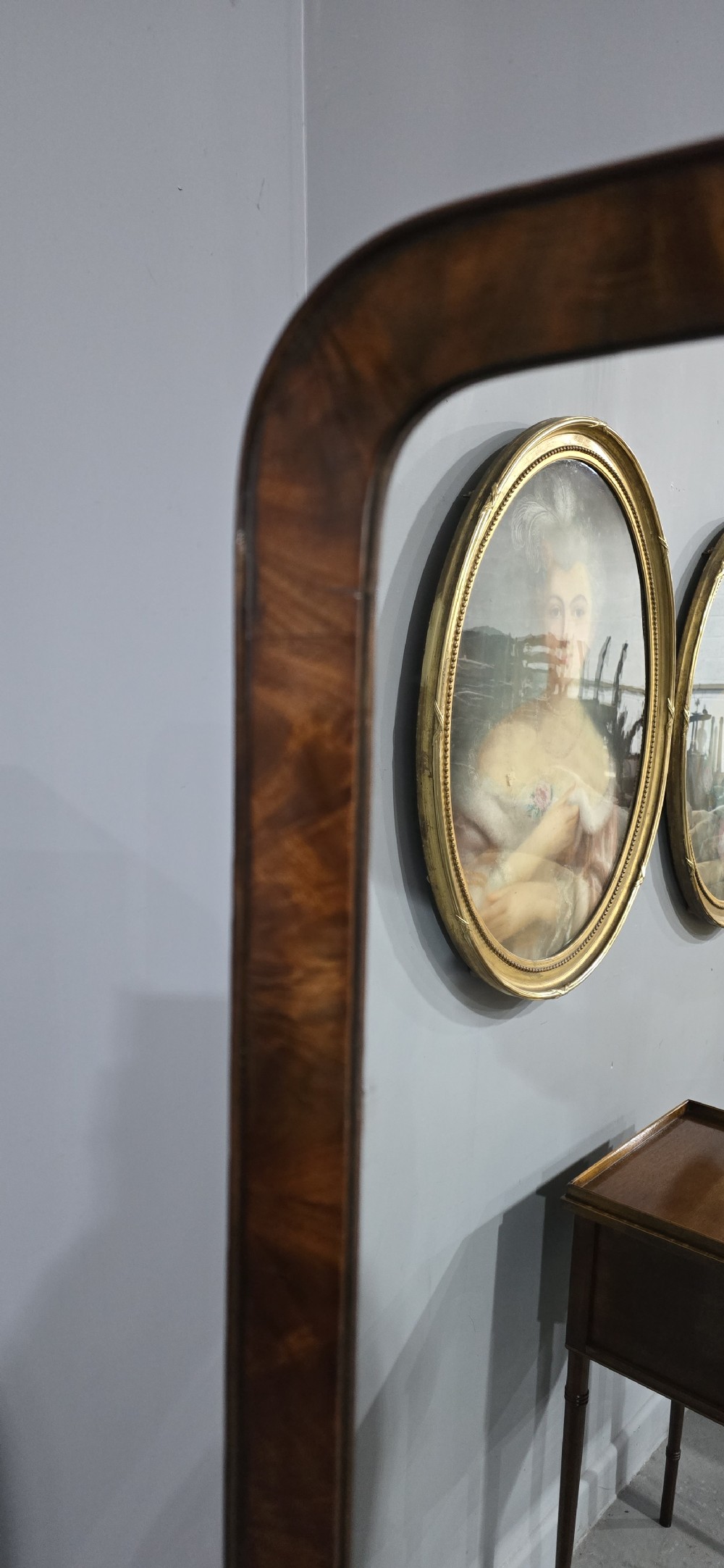 An antique Regency mahogany cheval mirror featuring a rectangular frame set between reeded upright posts on splayed legs. View XIII