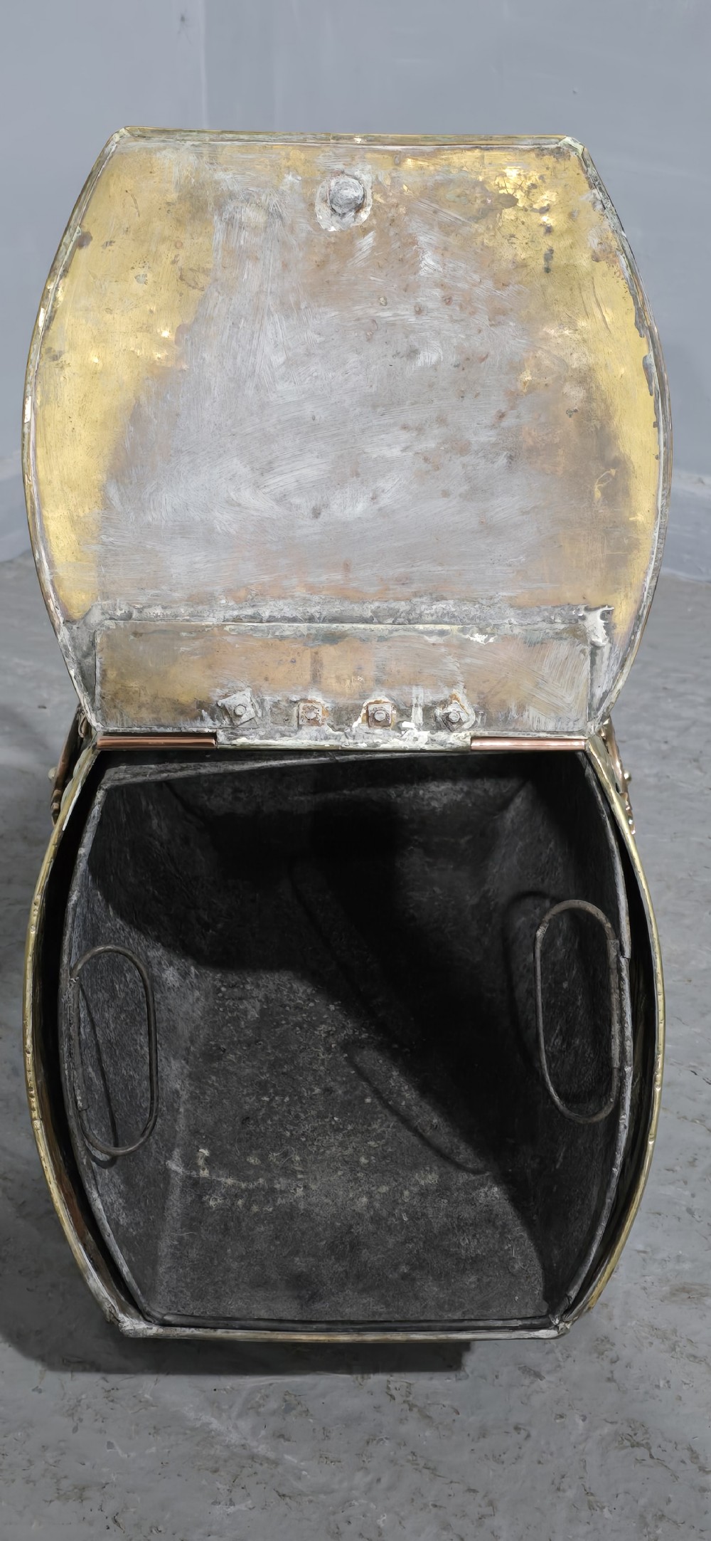 An embossed Victorian brass and copper coal scuttle with a turned wooden handle and detailed feet. View III