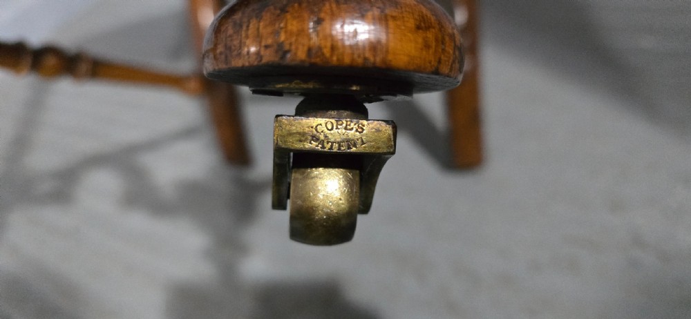 An antique walnut hall chair featuring spiral barley twist legs and supports, a carved crest with finials, and green patterned textile upholstery on the seat and backrest. View VII