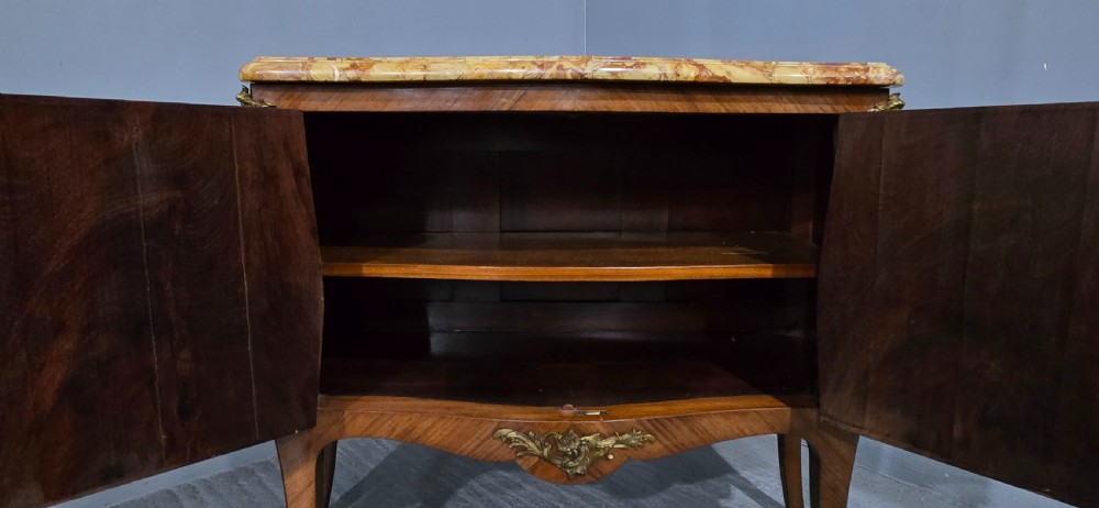 A French Louis XV style two-door cabinet featuring sunburst parquetry woodwork, a variegated marble top, cabriole legs, and ornate gilt bronze mounts. View VI