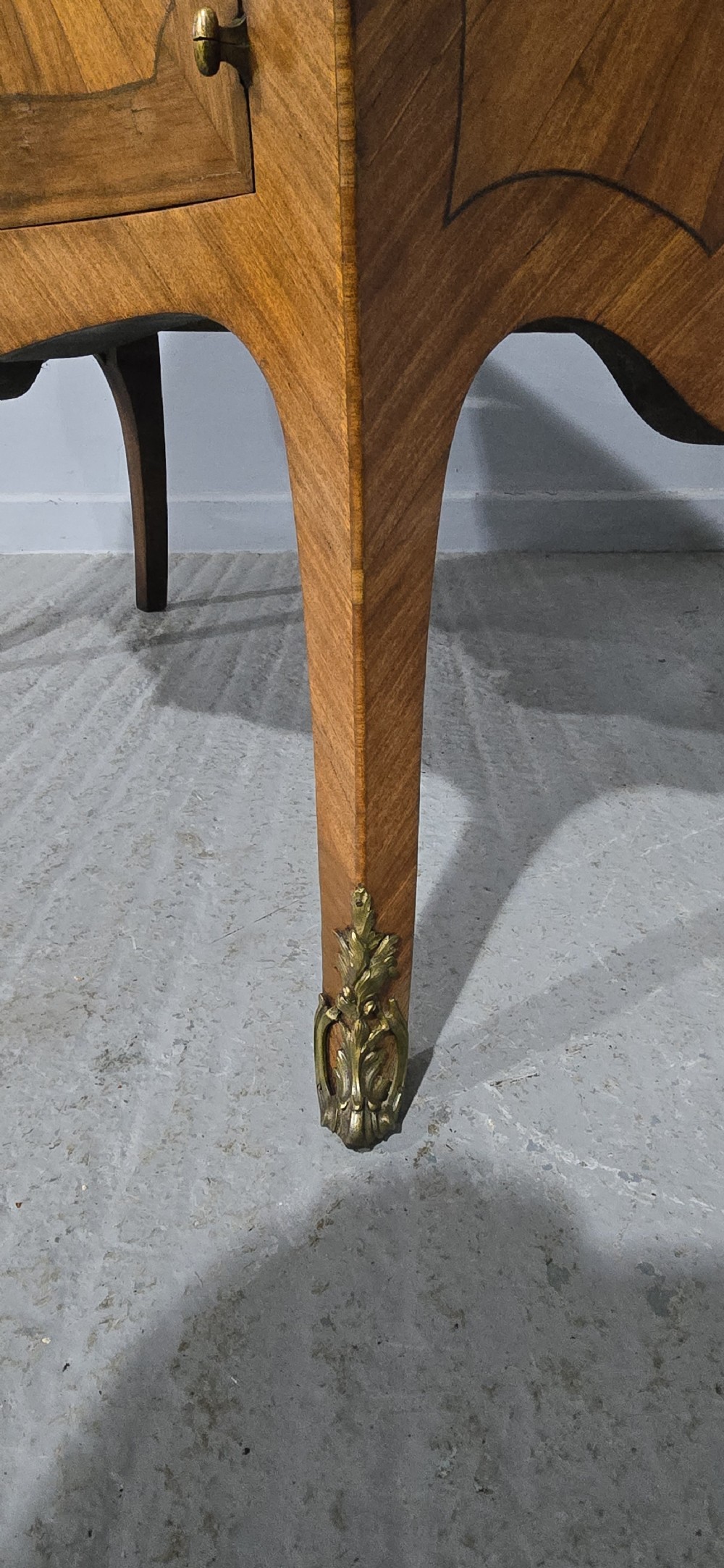 A French Louis XV style two-door cabinet featuring sunburst parquetry woodwork, a variegated marble top, cabriole legs, and ornate gilt bronze mounts. View XII