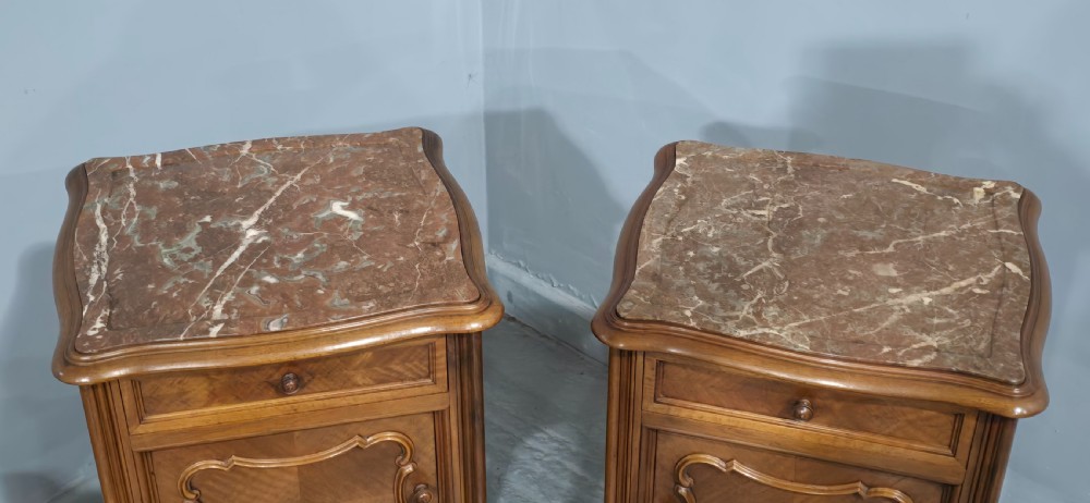 A pair of tall, slender French walnut bedside tables featuring marble tops, single upper drawers, panelled cupboard doors, and cabriole legs. View VI