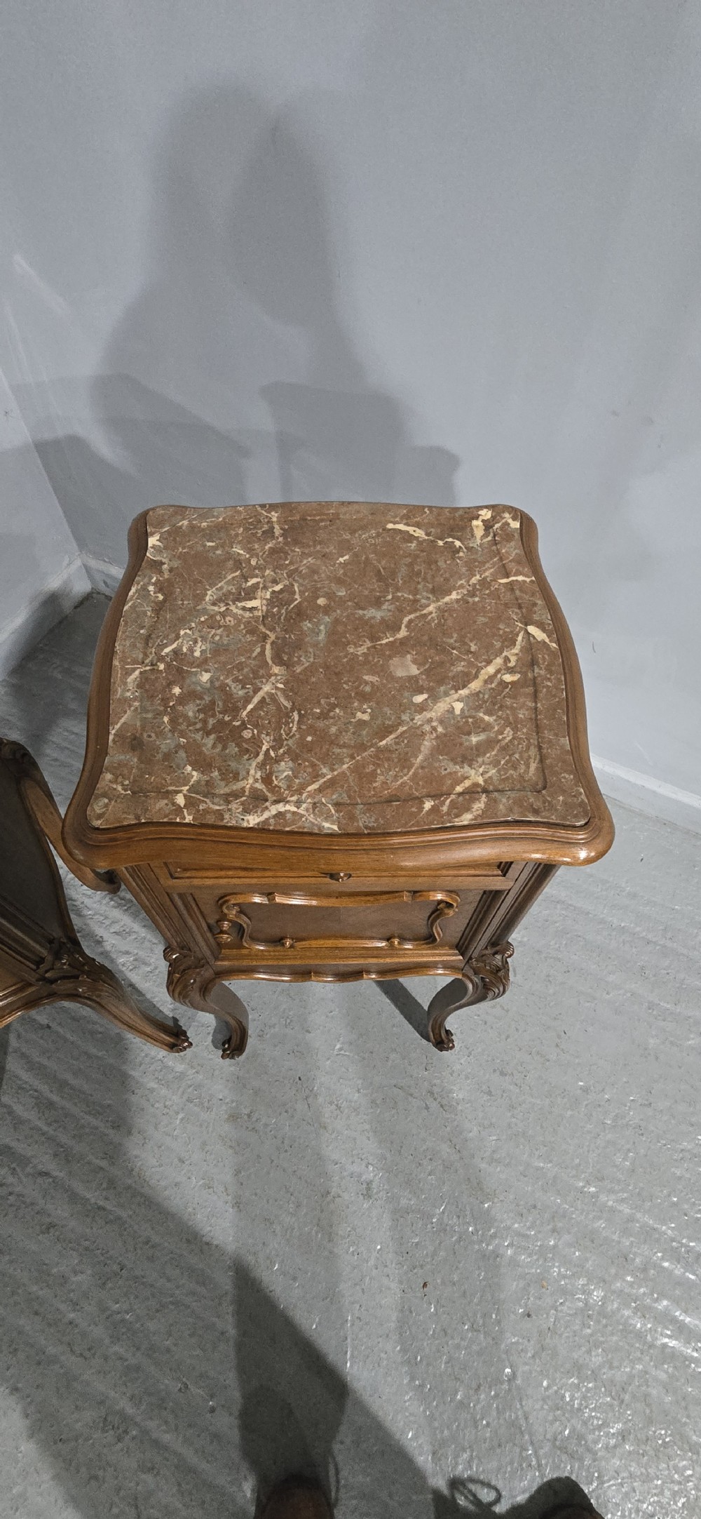 A pair of tall, slender French walnut bedside tables featuring marble tops, single upper drawers, panelled cupboard doors, and cabriole legs. View VIII