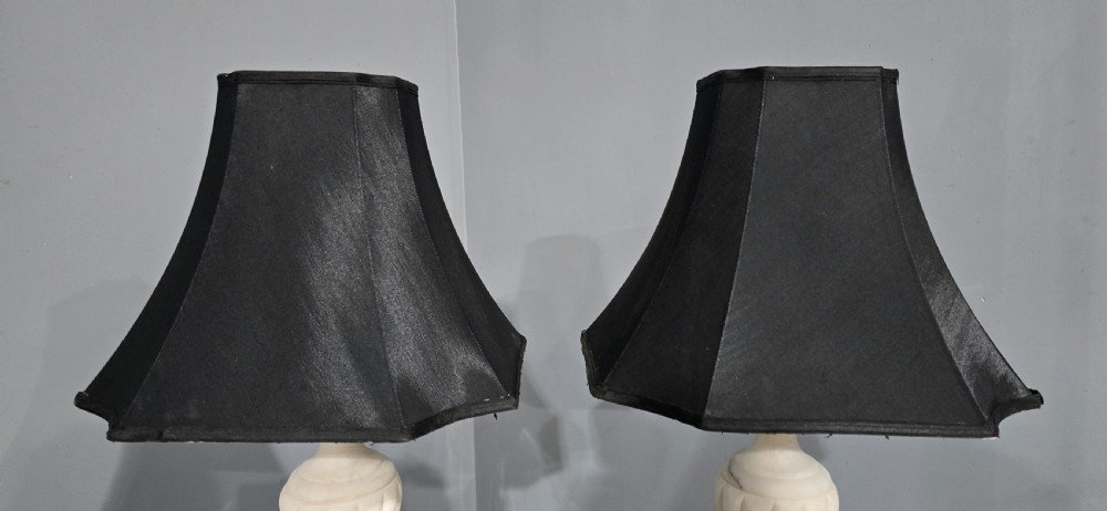 A pair of carved white marble table lamps with fluted urn bases and black flared shades. View III
