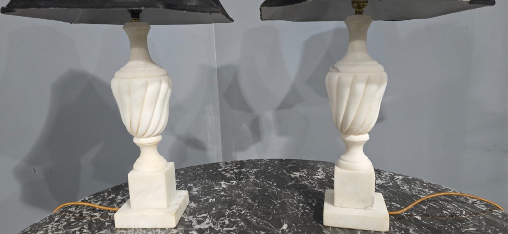 A pair of carved white marble table lamps with fluted urn bases and black flared shades. View IV