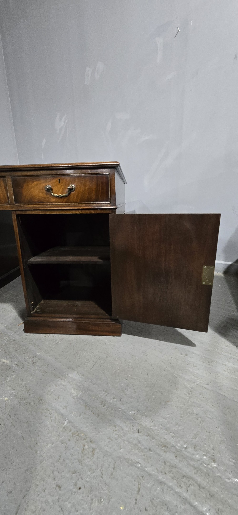 A double-pedestal mahogany partners desk featuring a leather-inset writing surface and brass swan-neck handles on multiple drawers. View XIII