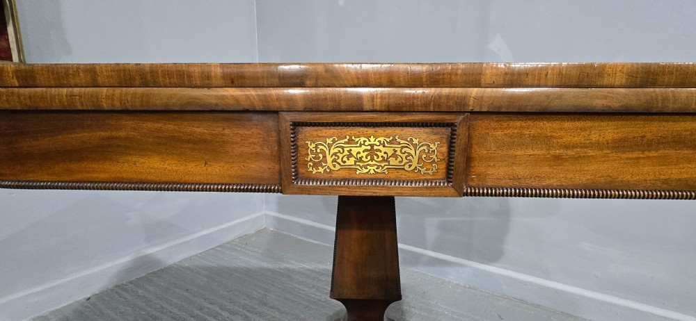 A Regency brass inlaid wooden card table featuring a fold-over top, central pedestal column, and four splayed legs with brass paw feet. View VIII