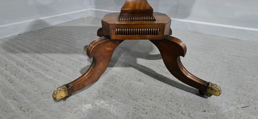 A Regency brass inlaid wooden card table featuring a fold-over top, central pedestal column, and four splayed legs with brass paw feet. View X