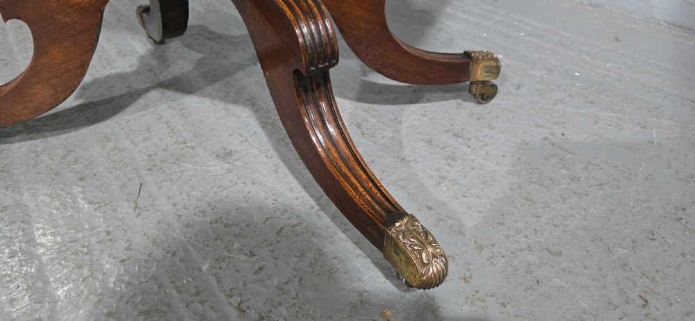 A Regency brass inlaid wooden card table featuring a fold-over top, central pedestal column, and four splayed legs with brass paw feet. View XII