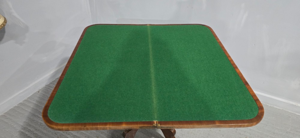 A Regency brass inlaid wooden card table featuring a fold-over top, central pedestal column, and four splayed legs with brass paw feet. View XV