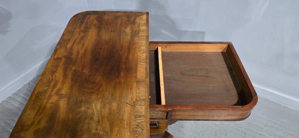 A Regency brass inlaid wooden card table featuring a fold-over top, central pedestal column, and four splayed legs with brass paw feet. View XVII