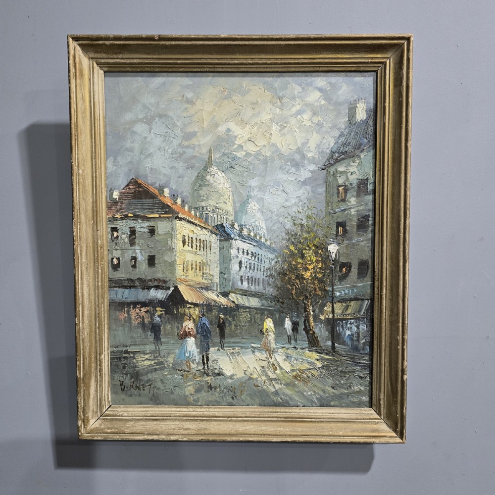 A framed oil painting depicting a Paris street scene with Sacre-Cur in the background, rendered in textured impasto brushstrokes.