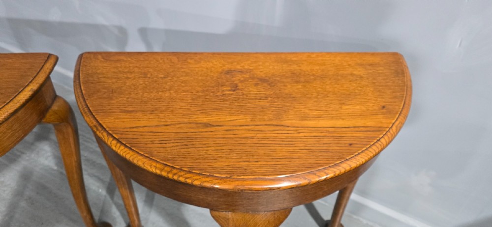 A pair of semi-circular oak console tables with smooth tops and slender cabriole legs terminating in pad feet. View III