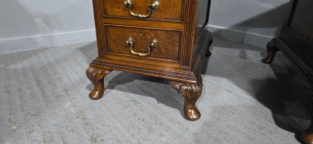 A Chippendale style mahogany pedestal desk featuring nine drawers with brass handles, a brown leather writing surface, and carved cabriole legs with ball-and-claw feet. View VIII