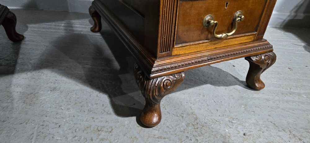 A Chippendale style mahogany pedestal desk featuring nine drawers with brass handles, a brown leather writing surface, and carved cabriole legs with ball-and-claw feet. View IX