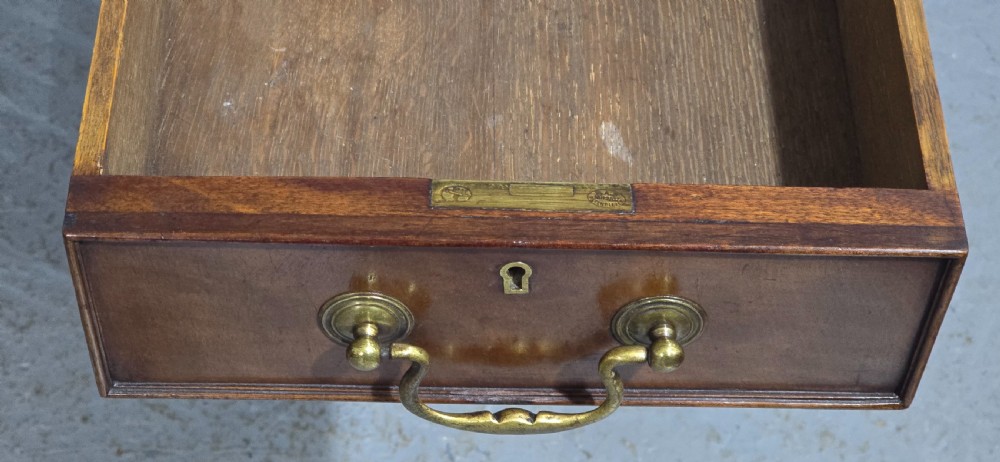 A Chippendale style mahogany pedestal desk featuring nine drawers with brass handles, a brown leather writing surface, and carved cabriole legs with ball-and-claw feet. View XII