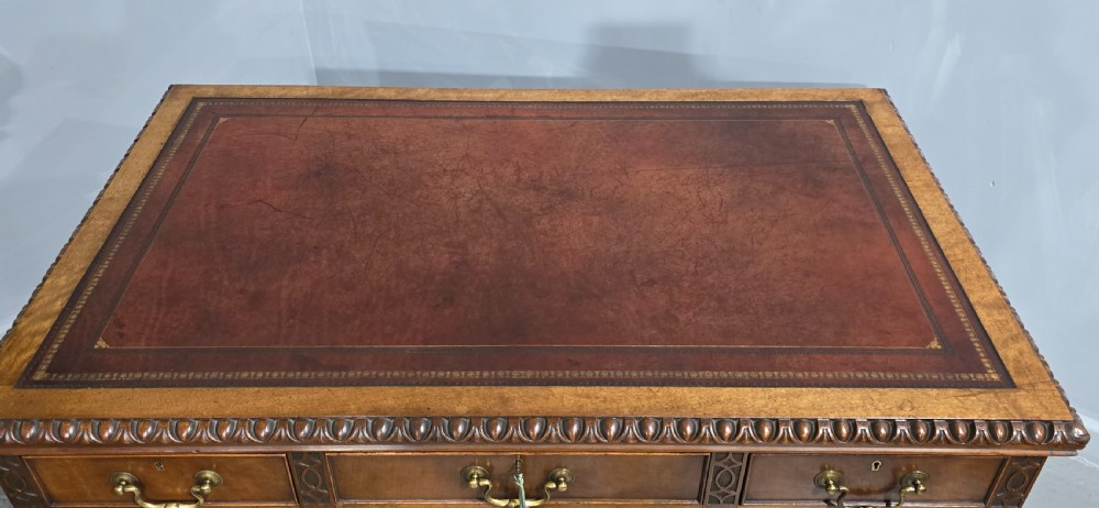 A Chippendale style mahogany pedestal desk featuring nine drawers with brass handles, a brown leather writing surface, and carved cabriole legs with ball-and-claw feet. View XIV