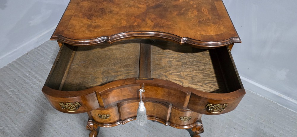A four-drawer walnut chest of drawers featuring an inward-curving concave front, brass handles, and cabriole feet. View VIII
