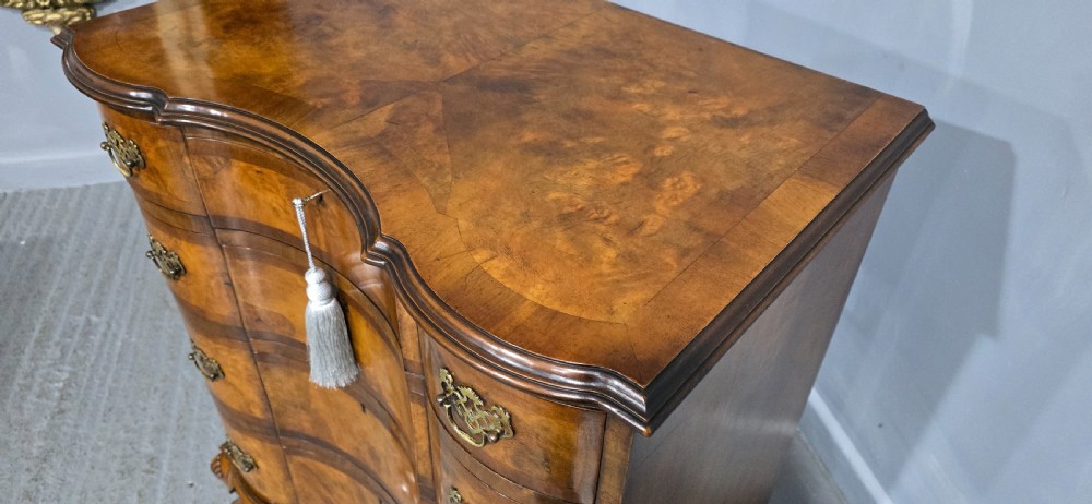 A four-drawer walnut chest of drawers featuring an inward-curving concave front, brass handles, and cabriole feet. View XIV