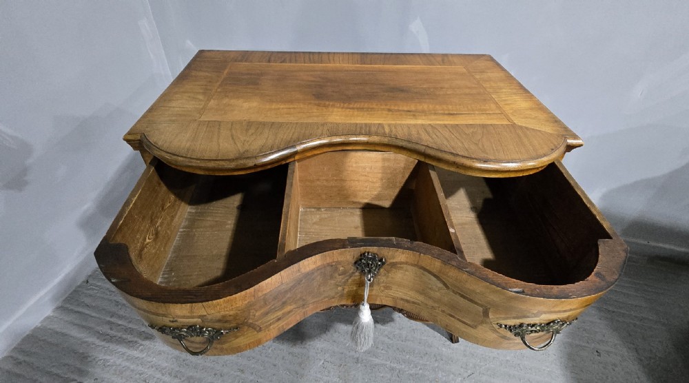 An antique walnut commode featuring two drawers with serpentine fronts, inlaid geometric banding, decorative brass handles, and carved cabriole legs. View XI