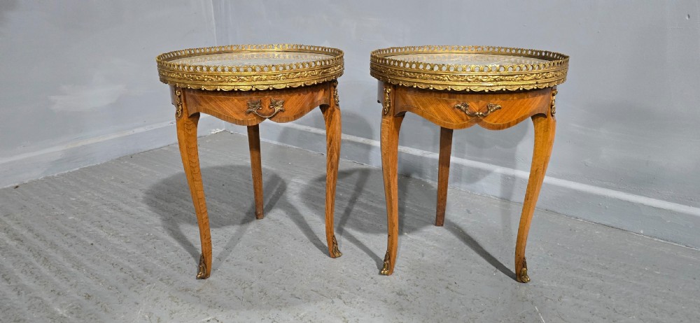 A pair of circular French kingwood side tables featuring grey marble tops, pierced brass galleries, and cabriole legs. View II